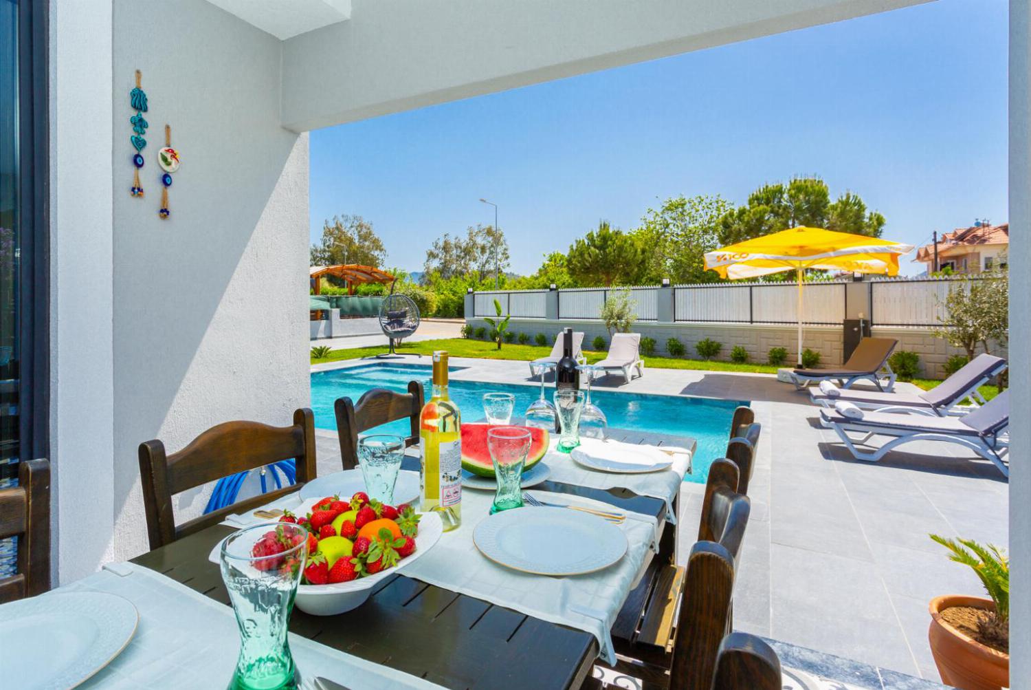 Outdoor dining area by the pool 