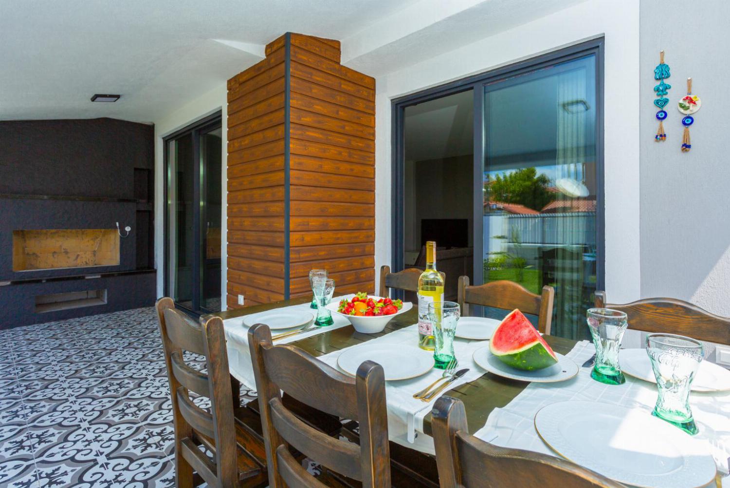 Outdoor dining, and barbecue area by the pool 