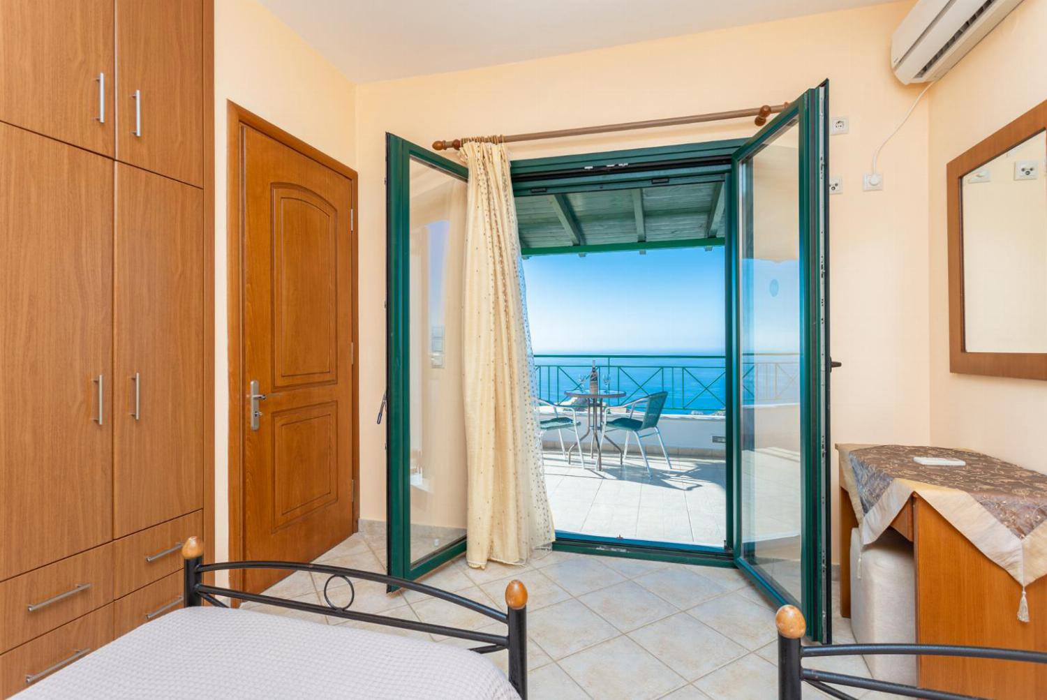 Twin bedroom with en suite bathroom, A/C, sea views, and terrace access