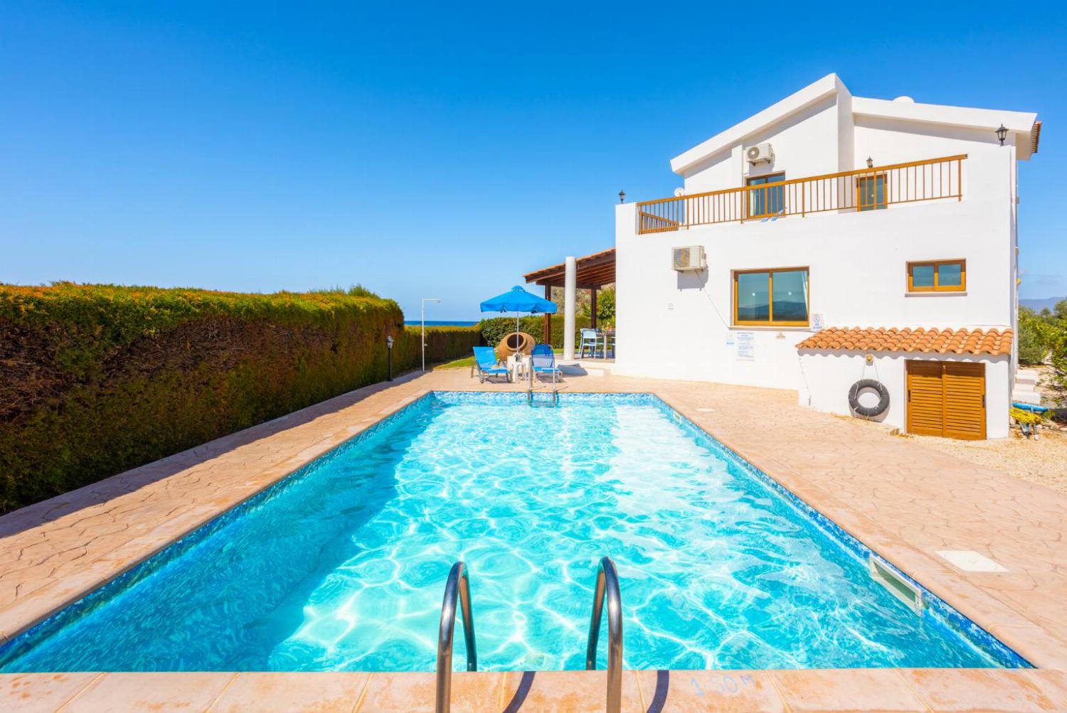 ,Beautiful villa with private pool, terrace, and garden with sea views