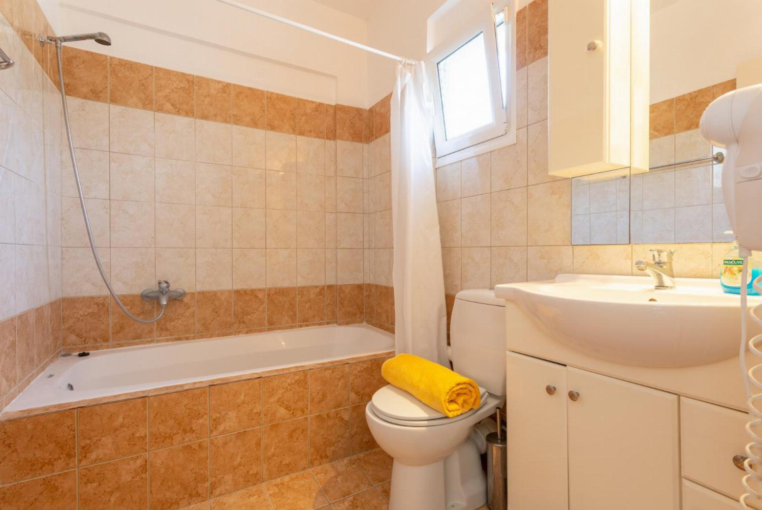 En suite bathroom with bath and overhead shower