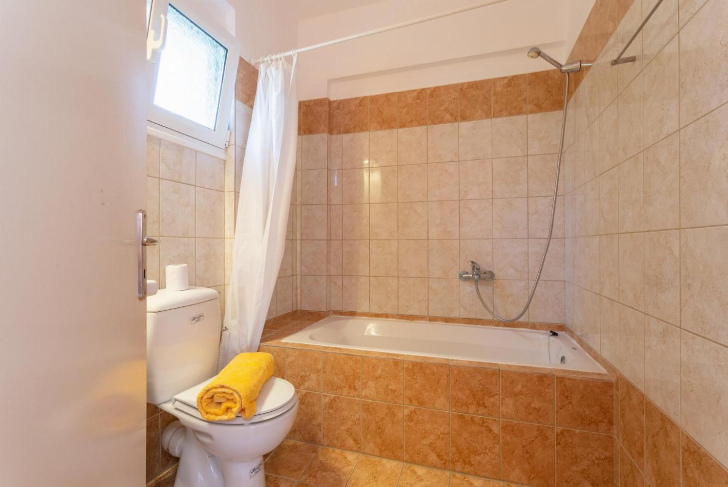 En suite bathroom with bath and overhead shower