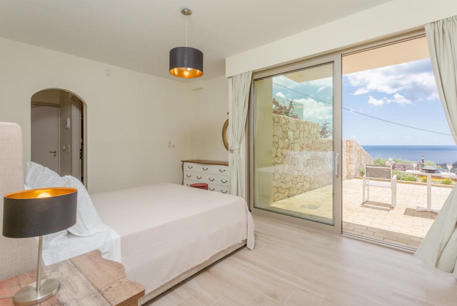 Double bedroom with en suite bathroom, A/C, and terrace access with sea views