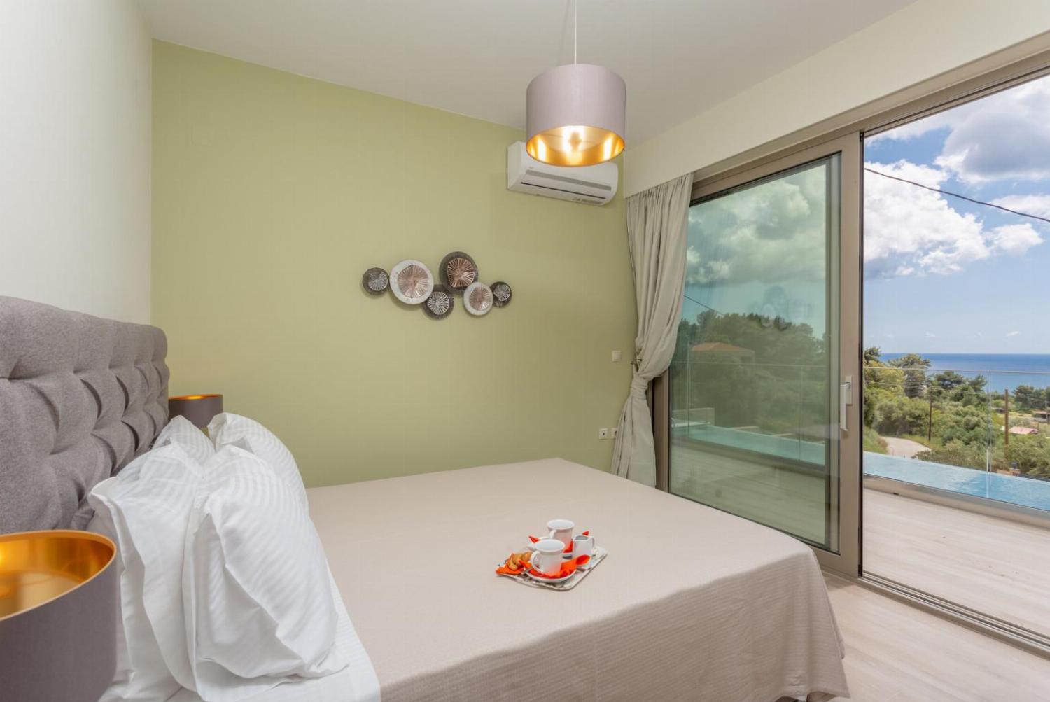 Double bedroom with en suite bathroom, A/C, and terrace access with sea views