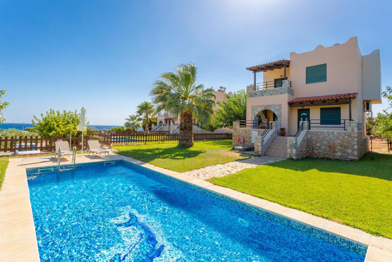 Beautiful villa with private pool, terrace, and lawn with sea views