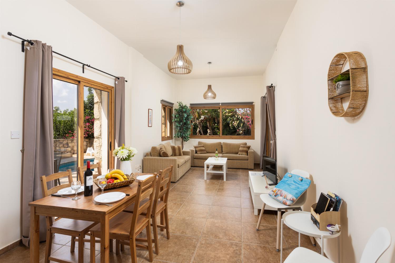 Open-plan living room with sofas, dining area, kitchen, WiFi internet, and satellite TV