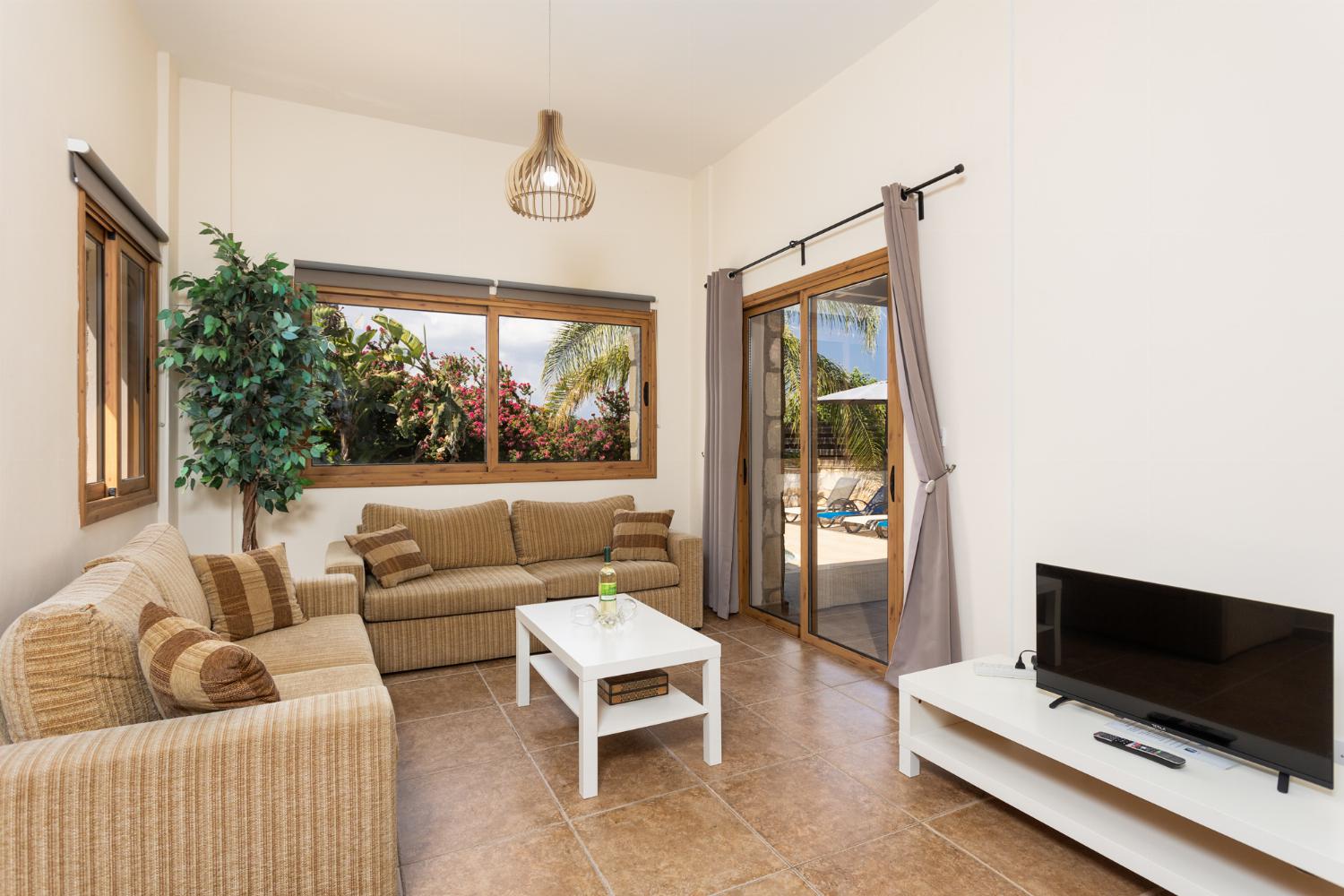 Open-plan living room with sofas, dining area, kitchen, WiFi internet, and satellite TV