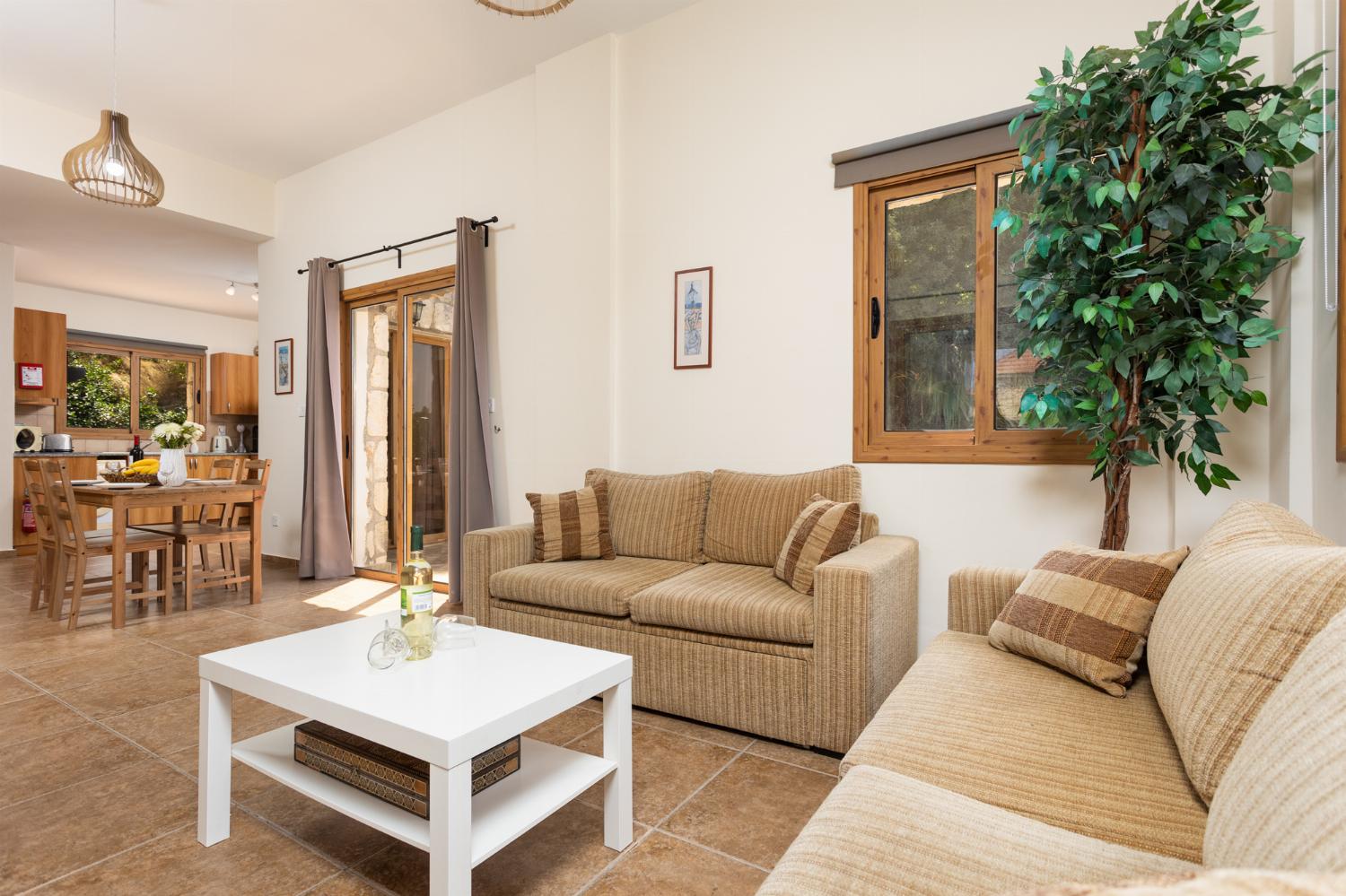 Open-plan living room with sofas, dining area, kitchen, WiFi internet, and satellite TV