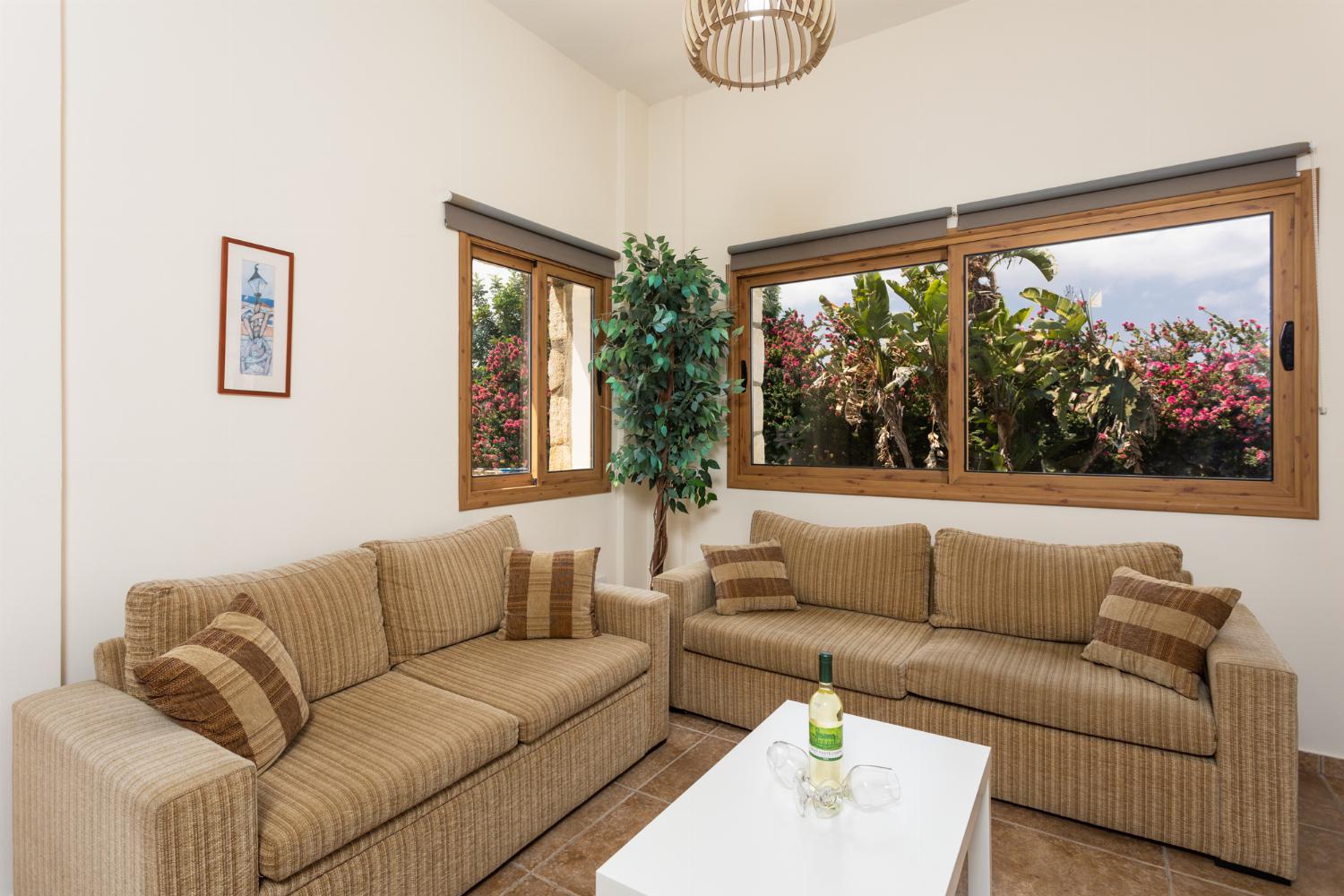 Open-plan living room with sofas, dining area, kitchen, WiFi internet, and satellite TV