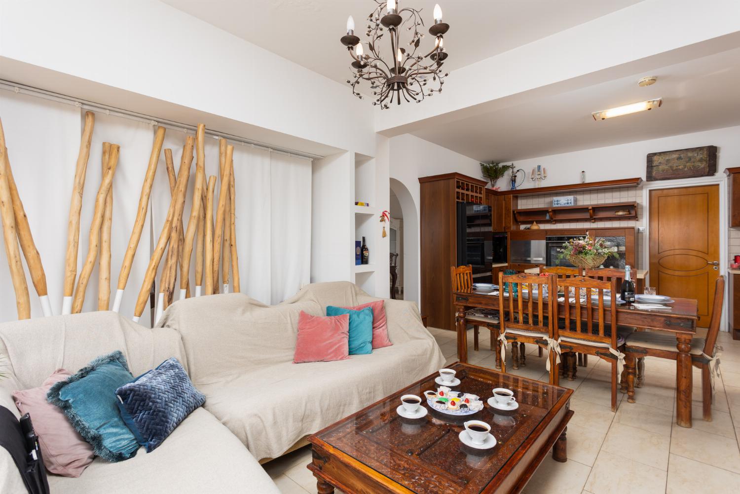 Main building: open-plan living room with sofas, dining area, kitchen, ornamental fireplace, A/C, WiFi internet, satellite TV, and sea views