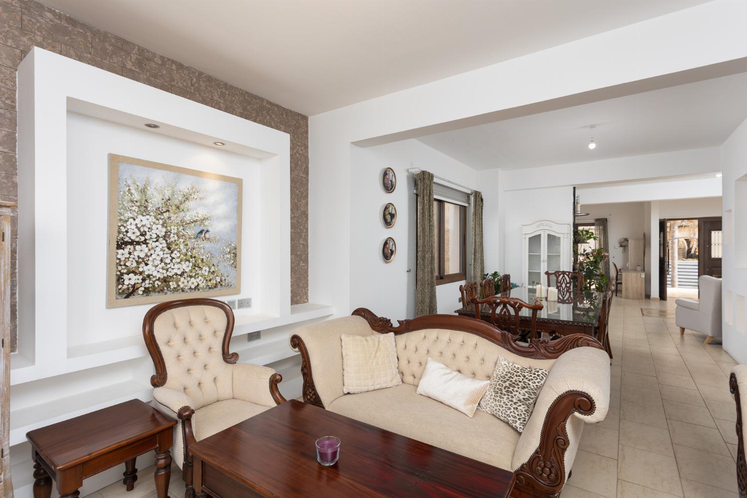 Main building: living room with sofas, dining area, A/C, WiFi internet, and sea views