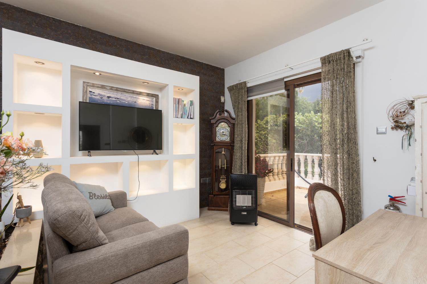 Main building: living area with sofa, WiFi internet, and satellite TV