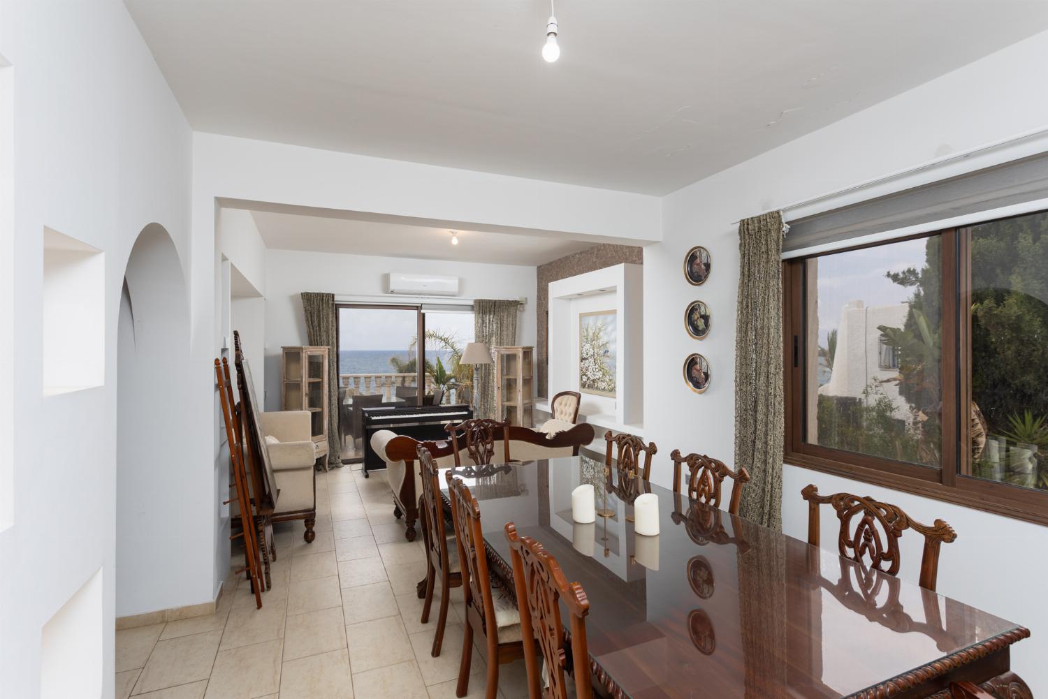 Main building: living room with sofas, dining area, A/C, WiFi internet, and sea views