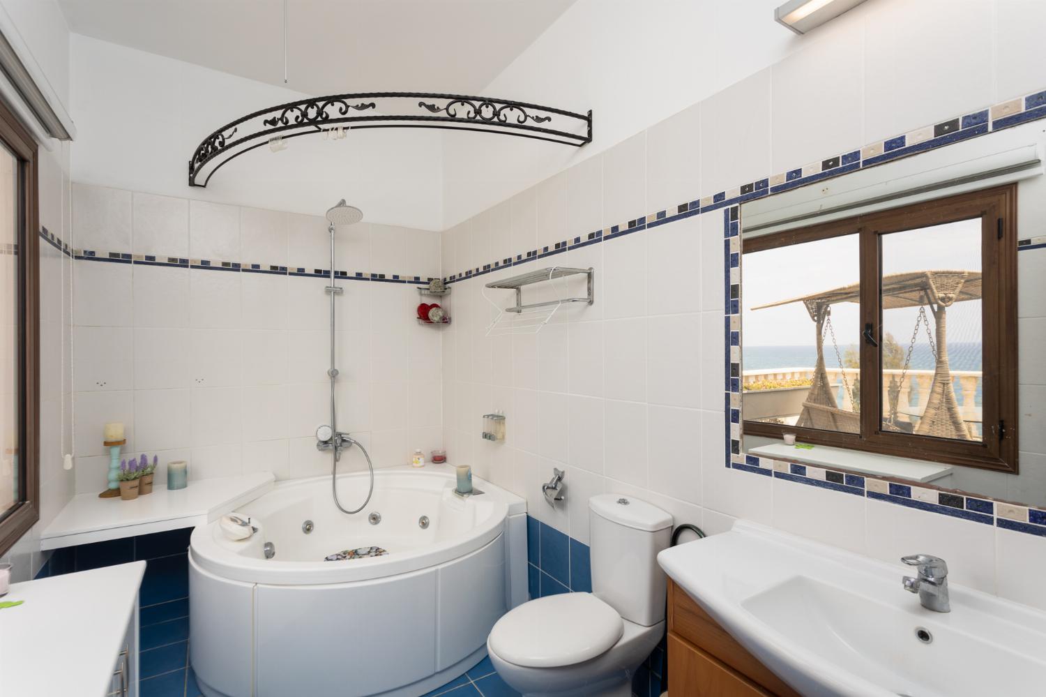 Main building: en suite bathroom with jacuzzi and shower