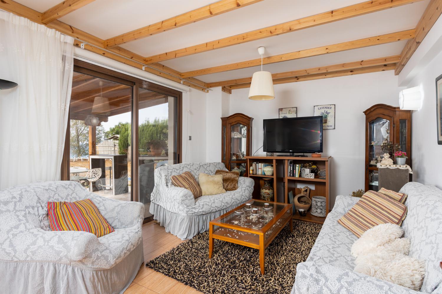 Front apartment: open-plan living room with sofas, dining area, kitchen, A/C, WiFi internet, satellite TV, and sea views
