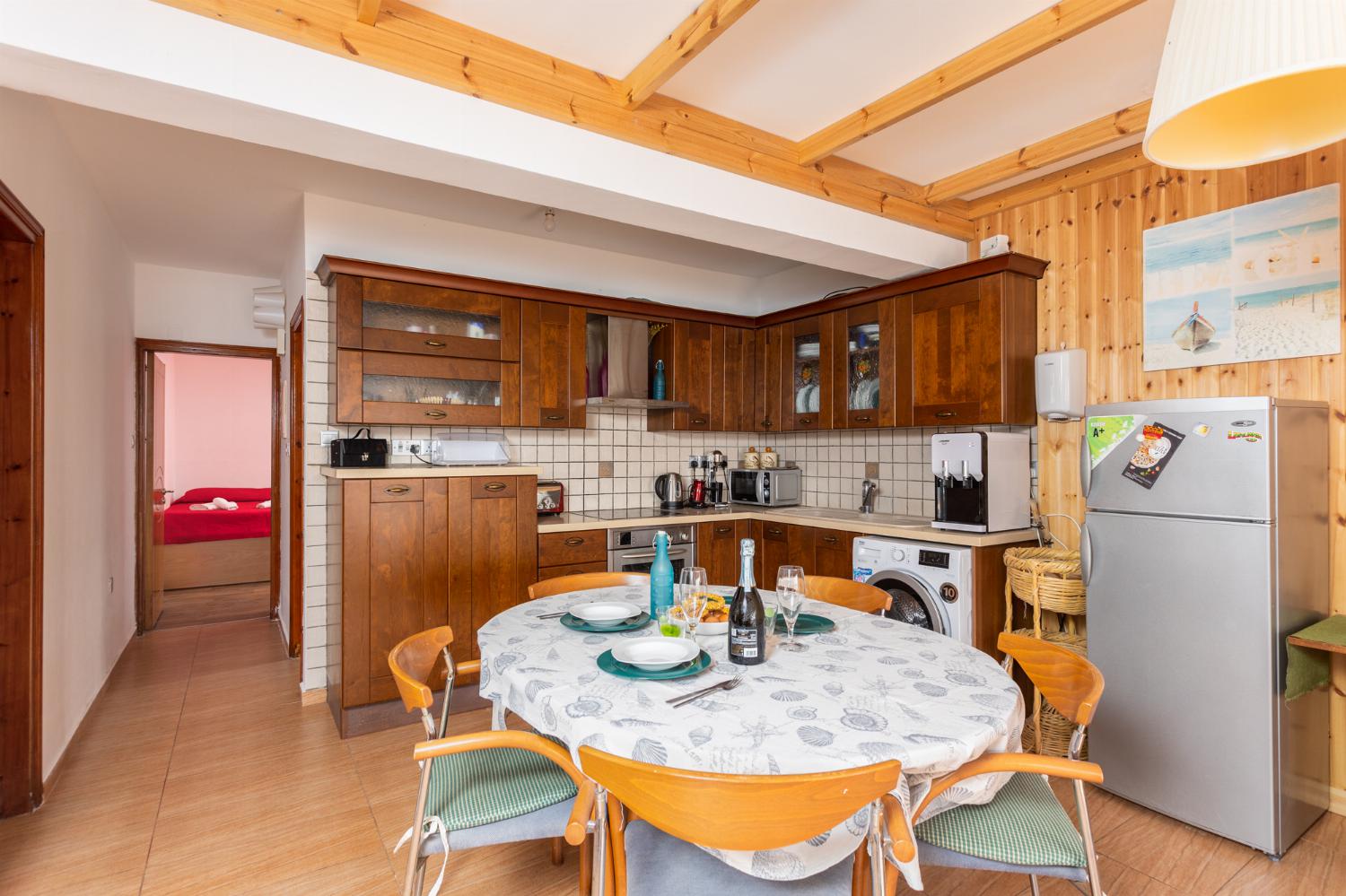 Front apartment: open-plan living room with sofas, dining area, kitchen, A/C, WiFi internet, satellite TV, and sea views