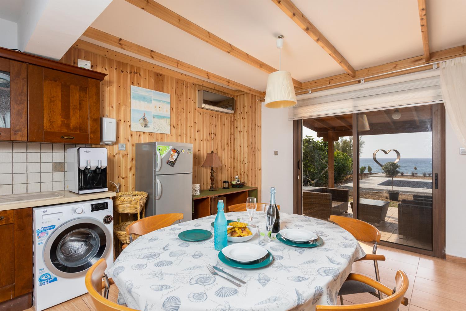Front apartment: open-plan living room with sofas, dining area, kitchen, A/C, WiFi internet, satellite TV, and sea views