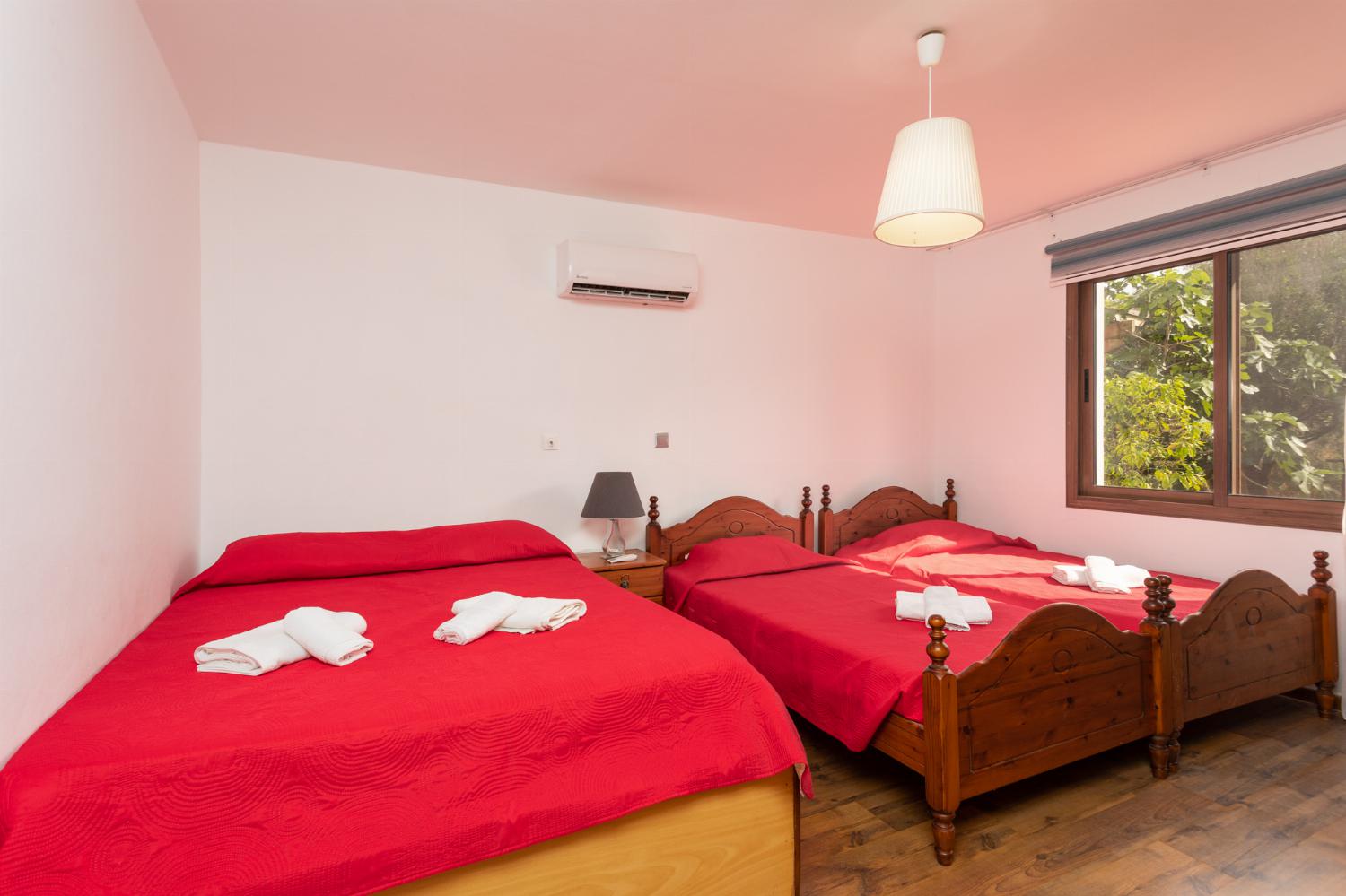 Front apartment: bedroom (one double bed, two singles) with A/C