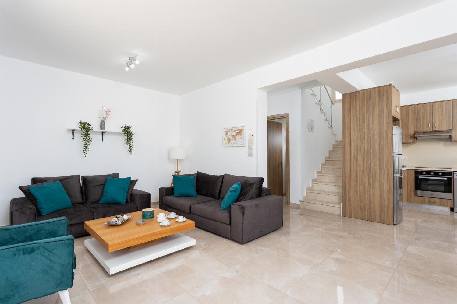 Open-plan living room with sofas, dining area, kitchen, A/C, WiFi internet, satellite TV, and sea views