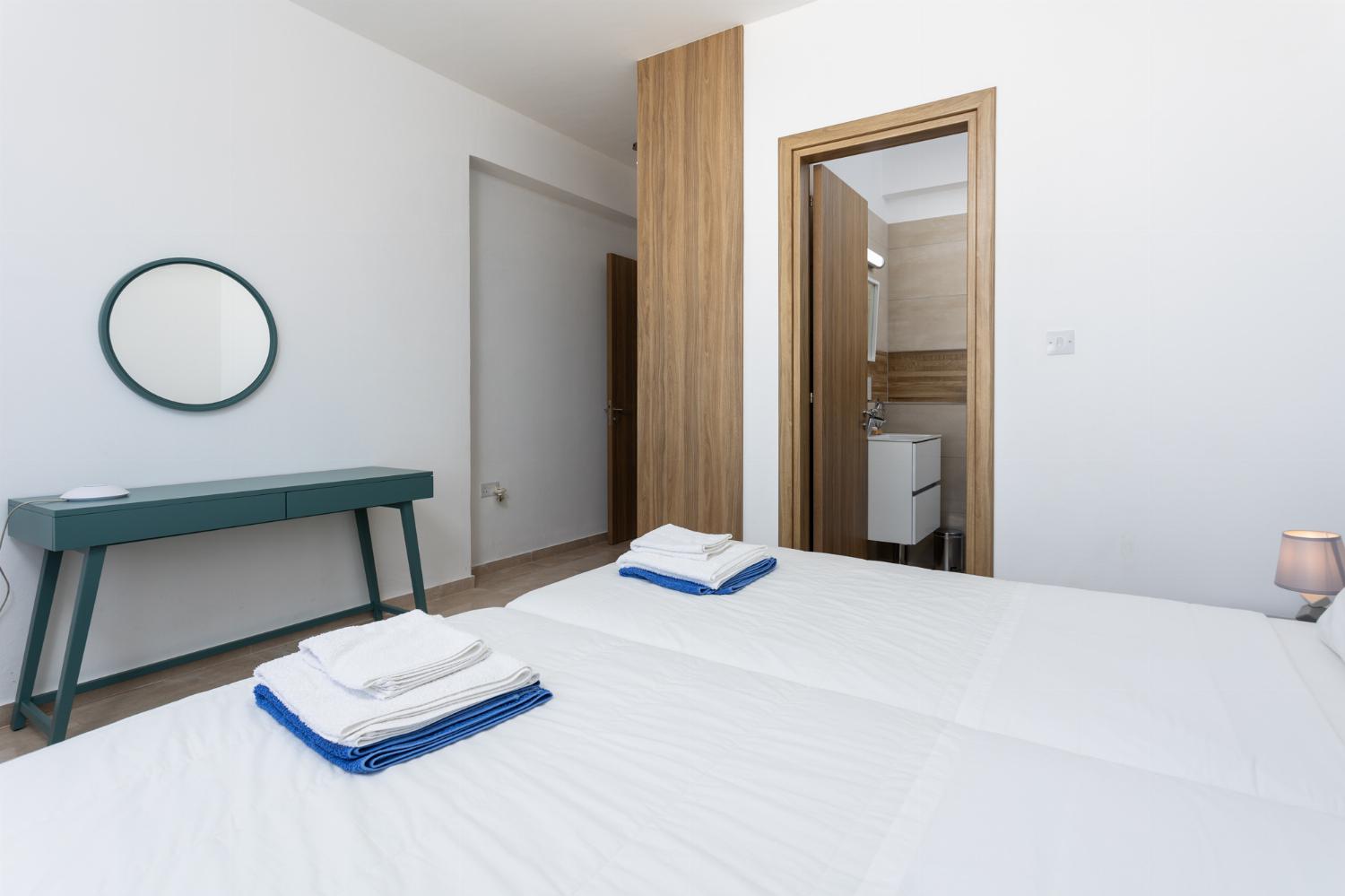 Twin bedroom with en suite bathroom, A/C, and sea views