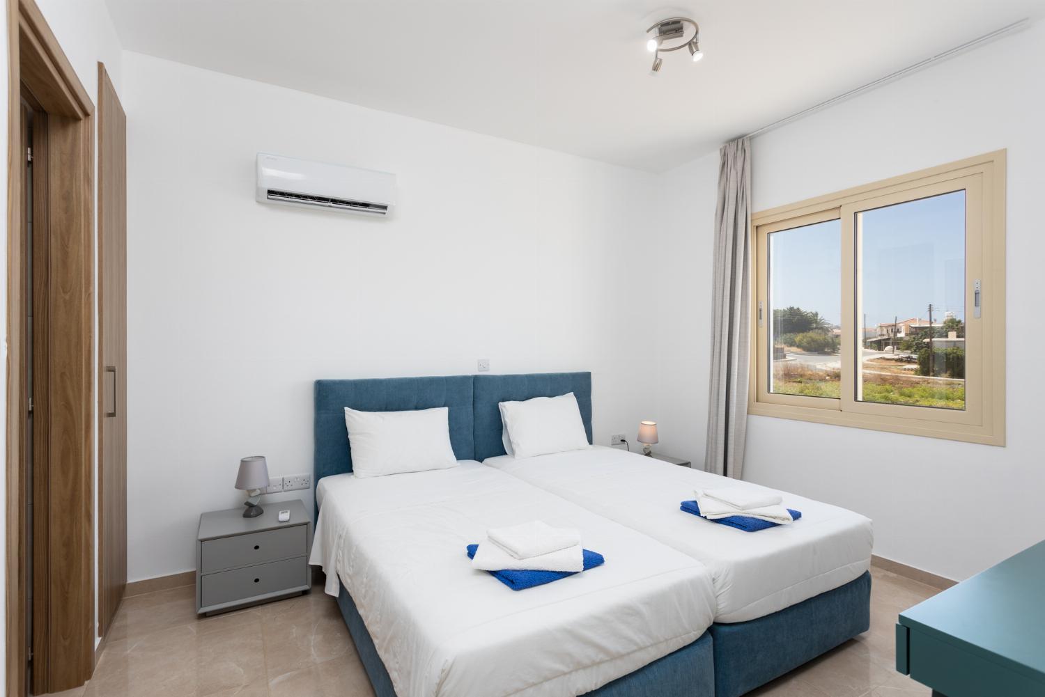 Twin bedroom with en suite bathroom and A/C