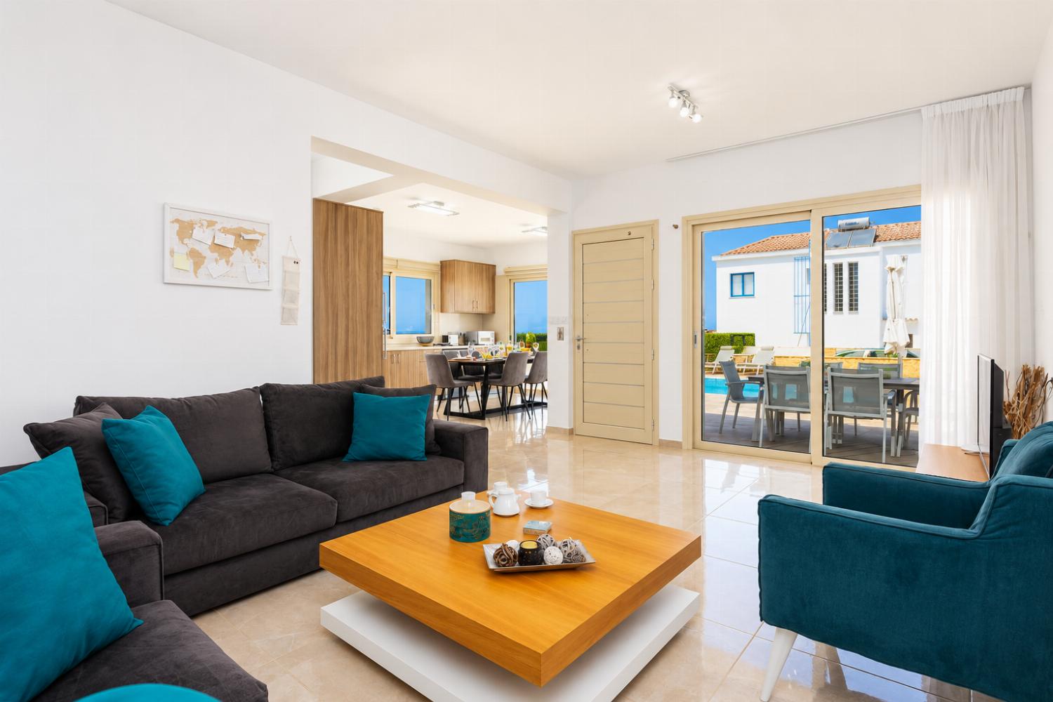 Open-plan living room with sofas, dining area, kitchen, A/C, WiFi internet, satellite TV, and sea views
