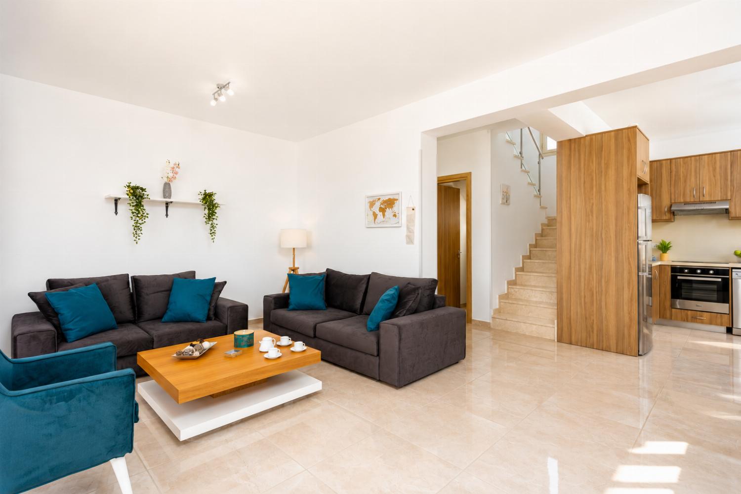 Open-plan living room with sofas, dining area, kitchen, A/C, WiFi internet, satellite TV, and sea views