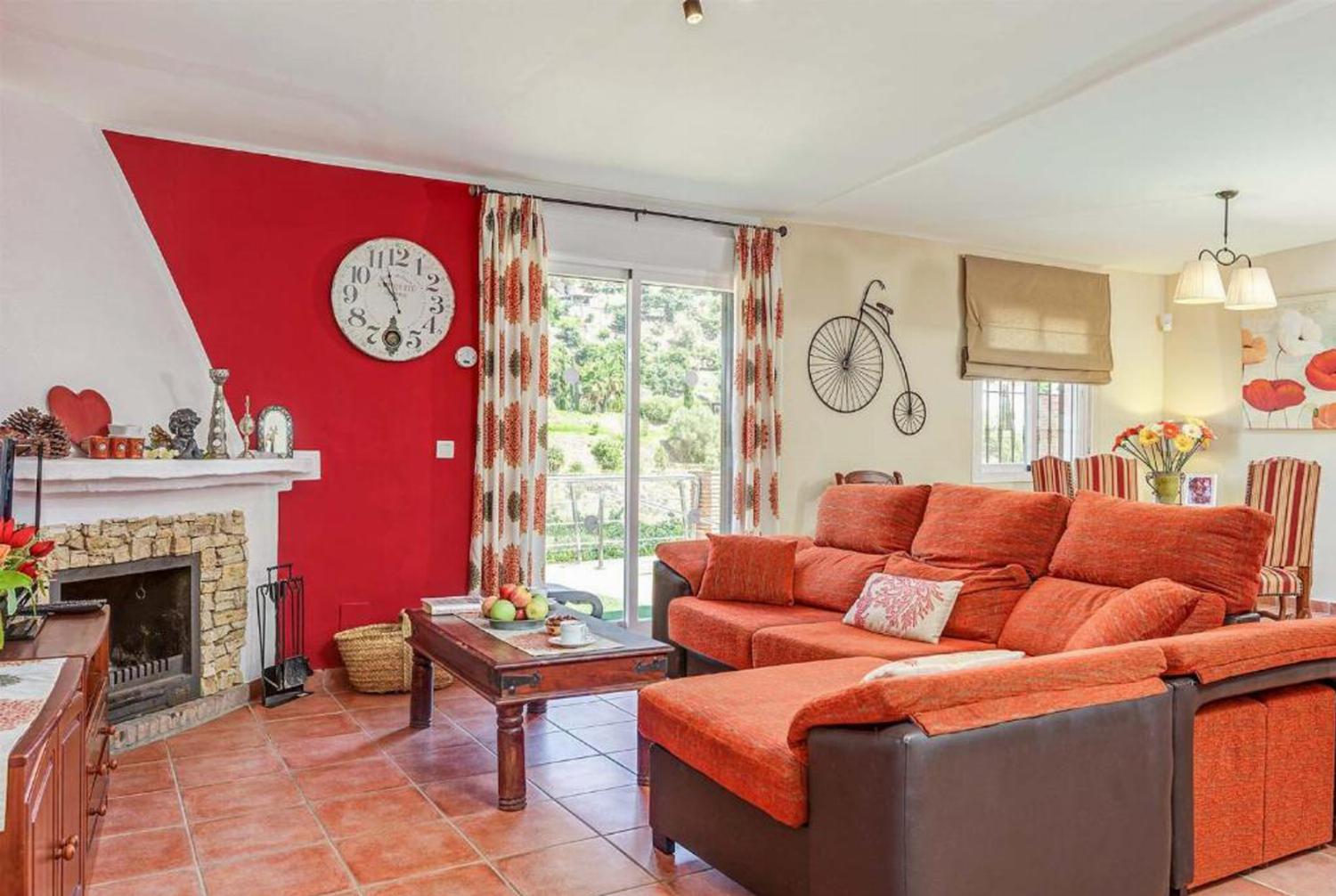 Open-plan living room with sofas, dining area, kitchen, WiFi internet, satellite TV, patio doors