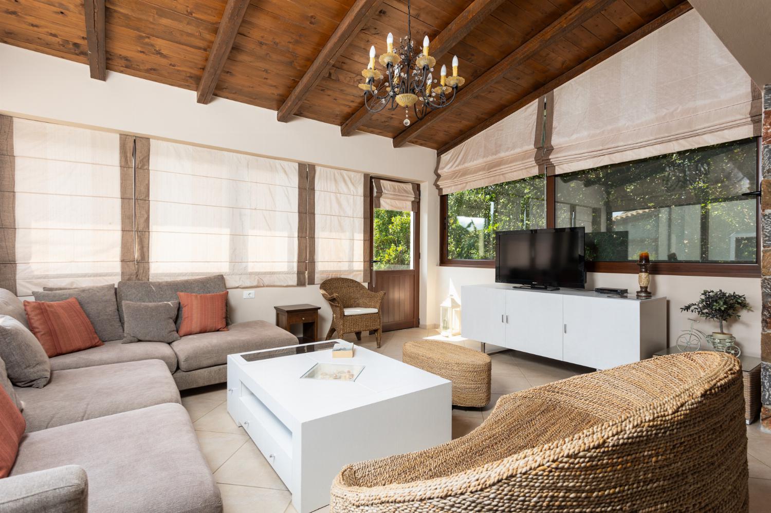 Open-plan living room with sofas, dining area, kitchen, mezzanine, ornamental fireplace, A/C, WiFi internet, and satellite TV