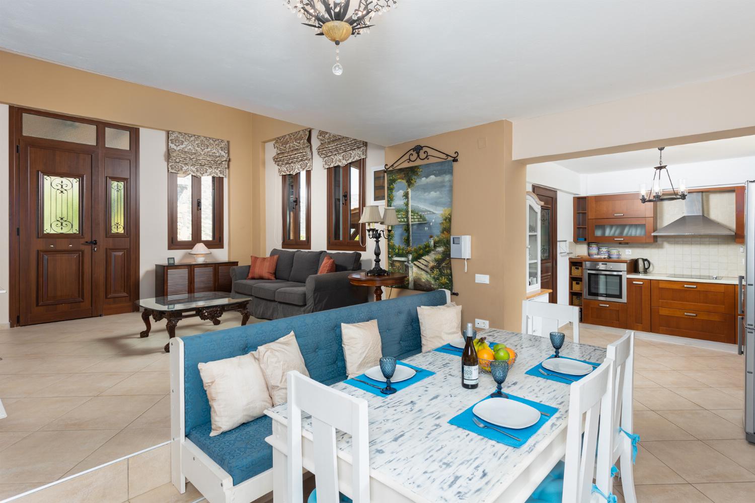Open-plan living room with sofas, dining area, kitchen, mezzanine, ornamental fireplace, A/C, WiFi internet, and satellite TV