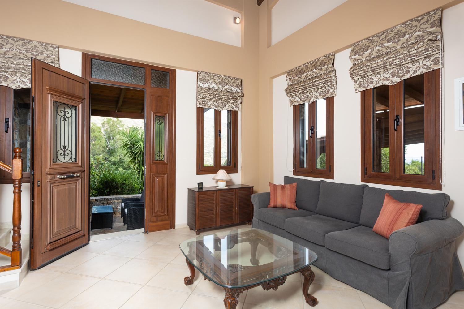 Open-plan living room with sofas, dining area, kitchen, mezzanine, ornamental fireplace, A/C, WiFi internet, and satellite TV