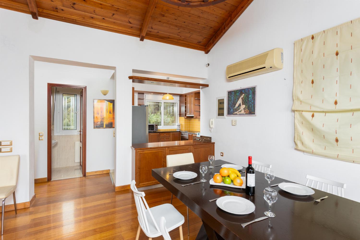 Open-plan living room with sofa, dining area, kitchen, A/C, WiFi internet, satellite TV, and sea views