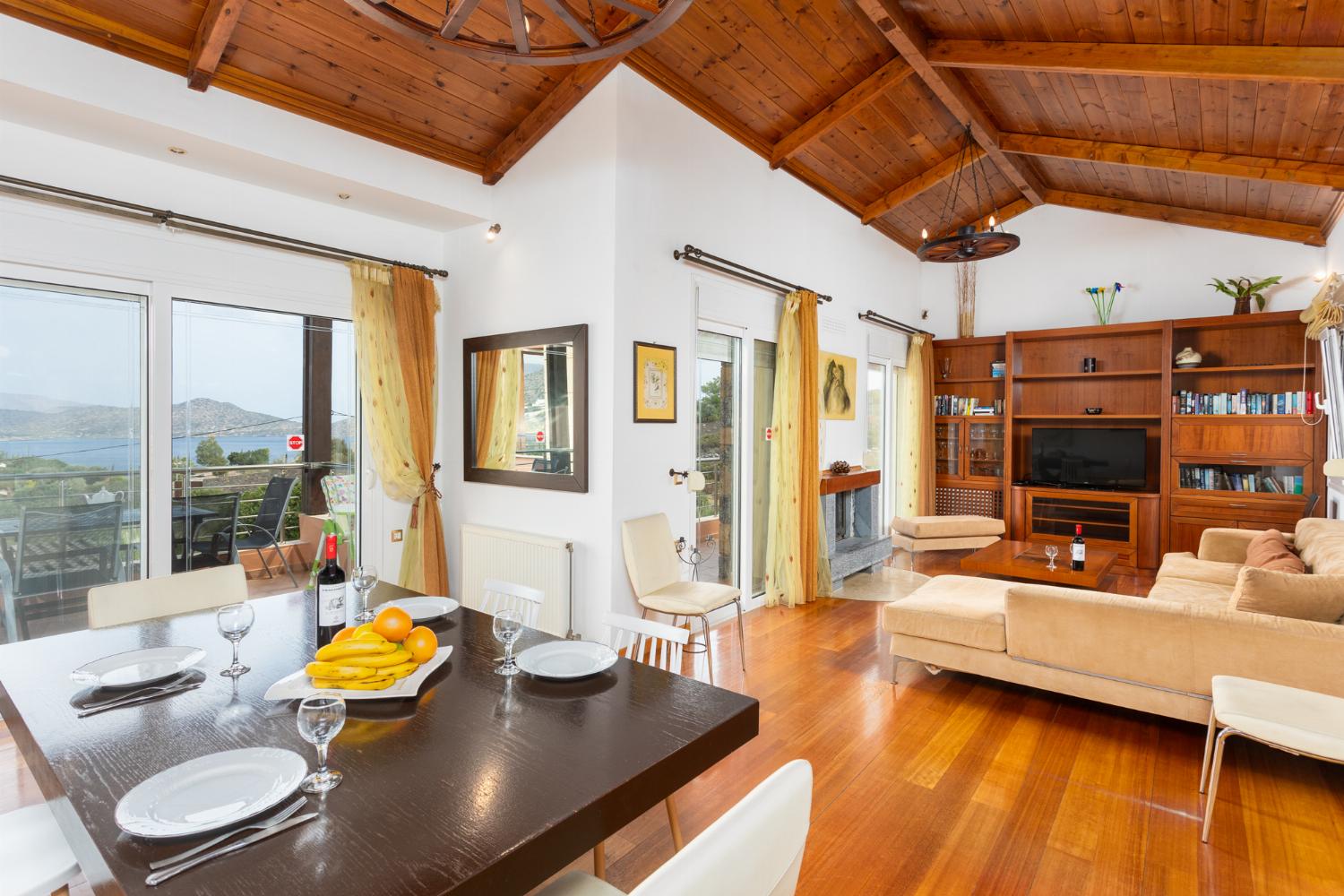 Open-plan living room with sofa, dining area, kitchen, A/C, WiFi internet, satellite TV, and sea views