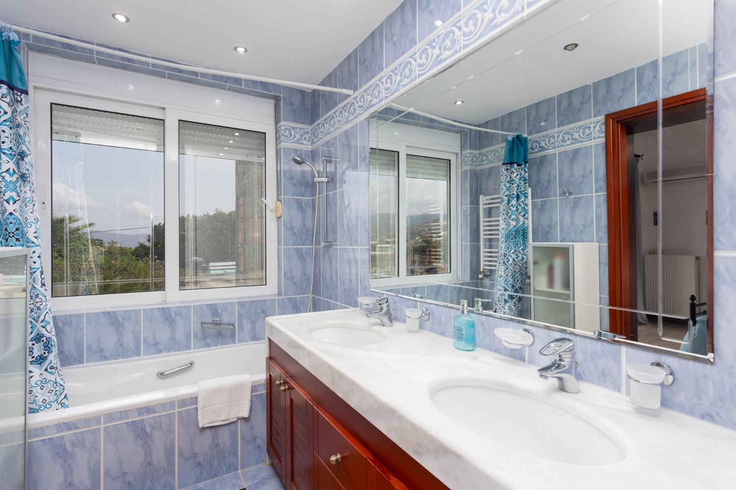 En suite bathroom with bath and shower
