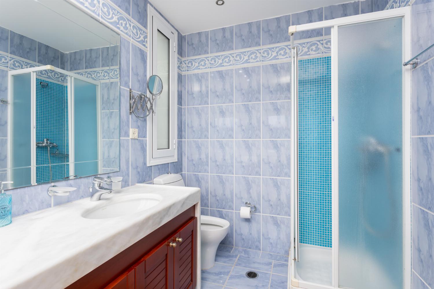 En suite bathroom with bath and shower