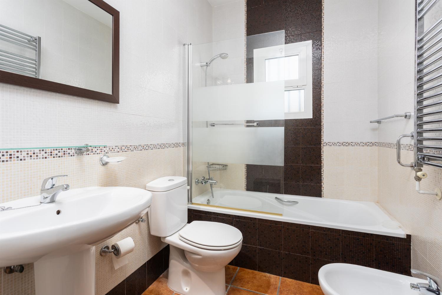 En suite bathroom with bath and shower