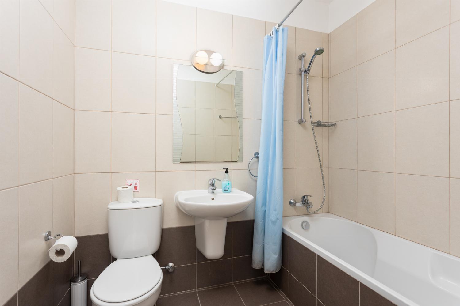 En suite bathroom with bath and shower