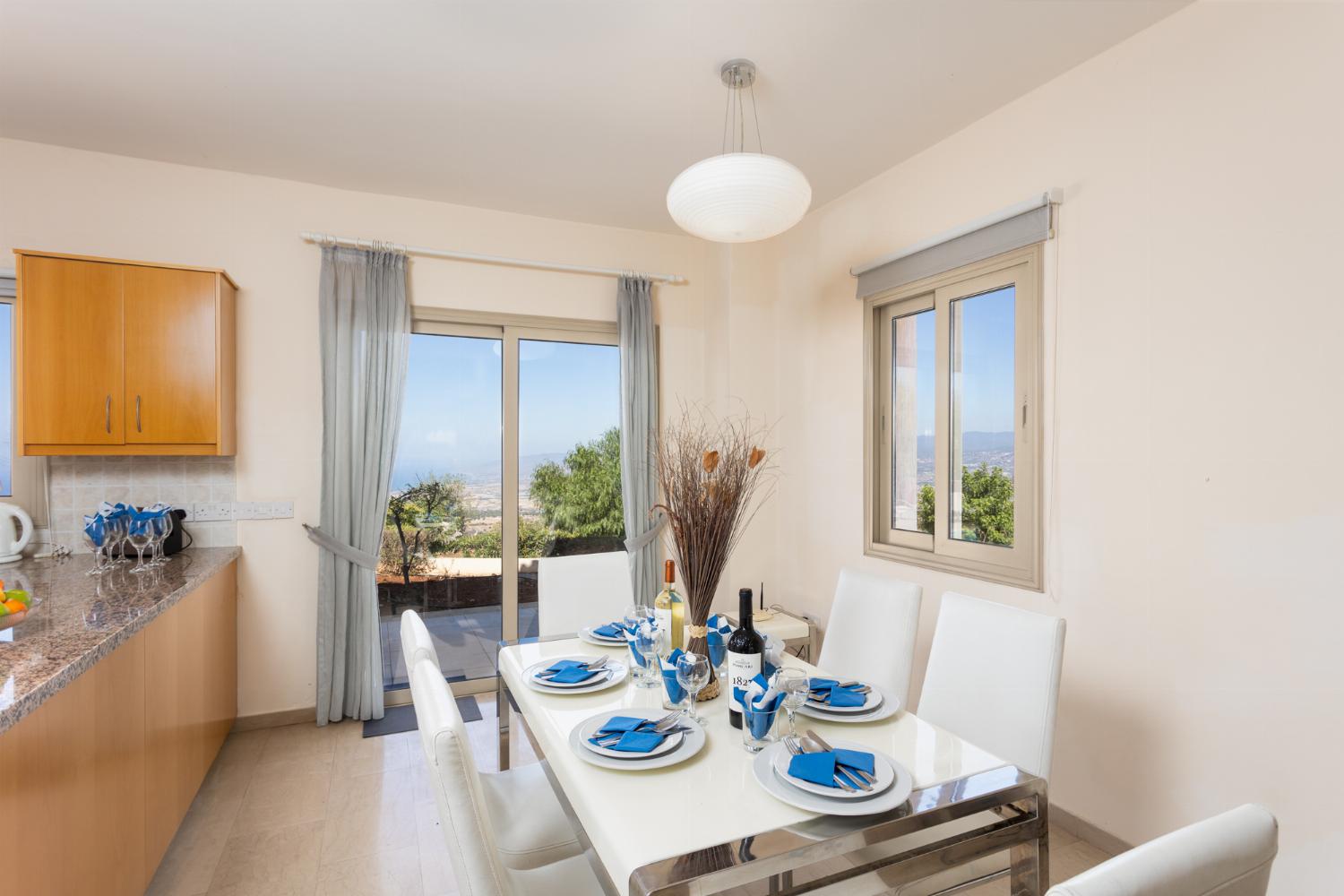 Open-plan living room with sofas, dining area, kitchen, ornamental fireplace, A/C, WiFi internet, and satellite TV