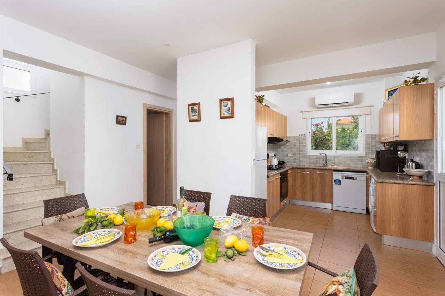 Open-plan living room with sofas, dining area, kitchen, A/C, WiFi internet, and satellite TV