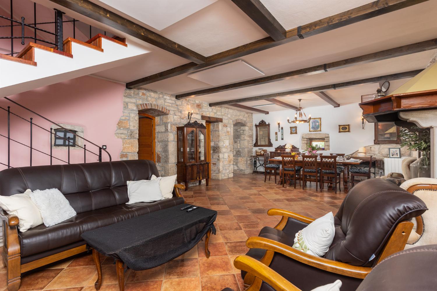Living room on ground floor with sofas, dining area, ornamental fireplace, WiFi internet, and satellite TV