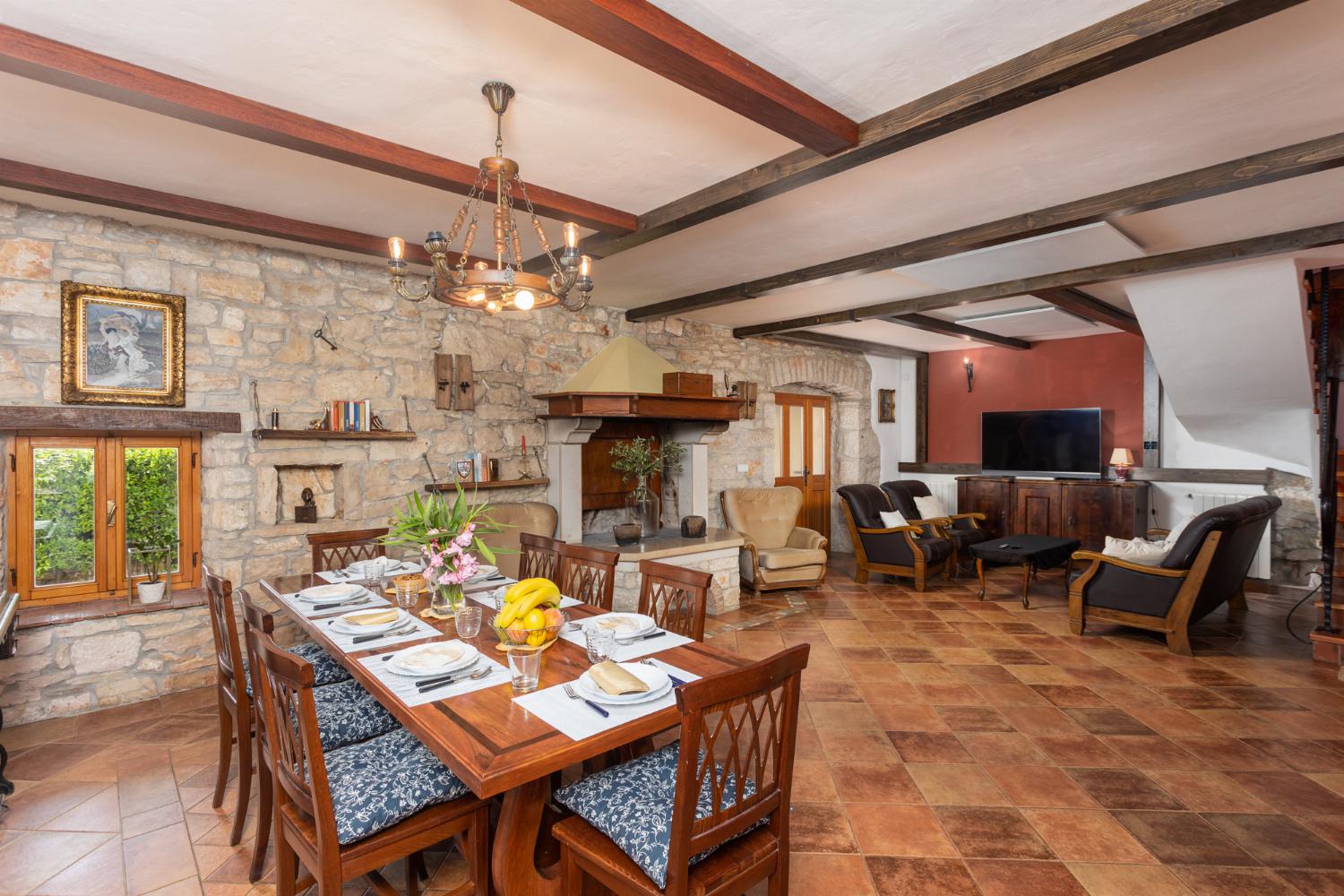 Living room on ground floor with sofas, dining area, ornamental fireplace, WiFi internet, and satellite TV