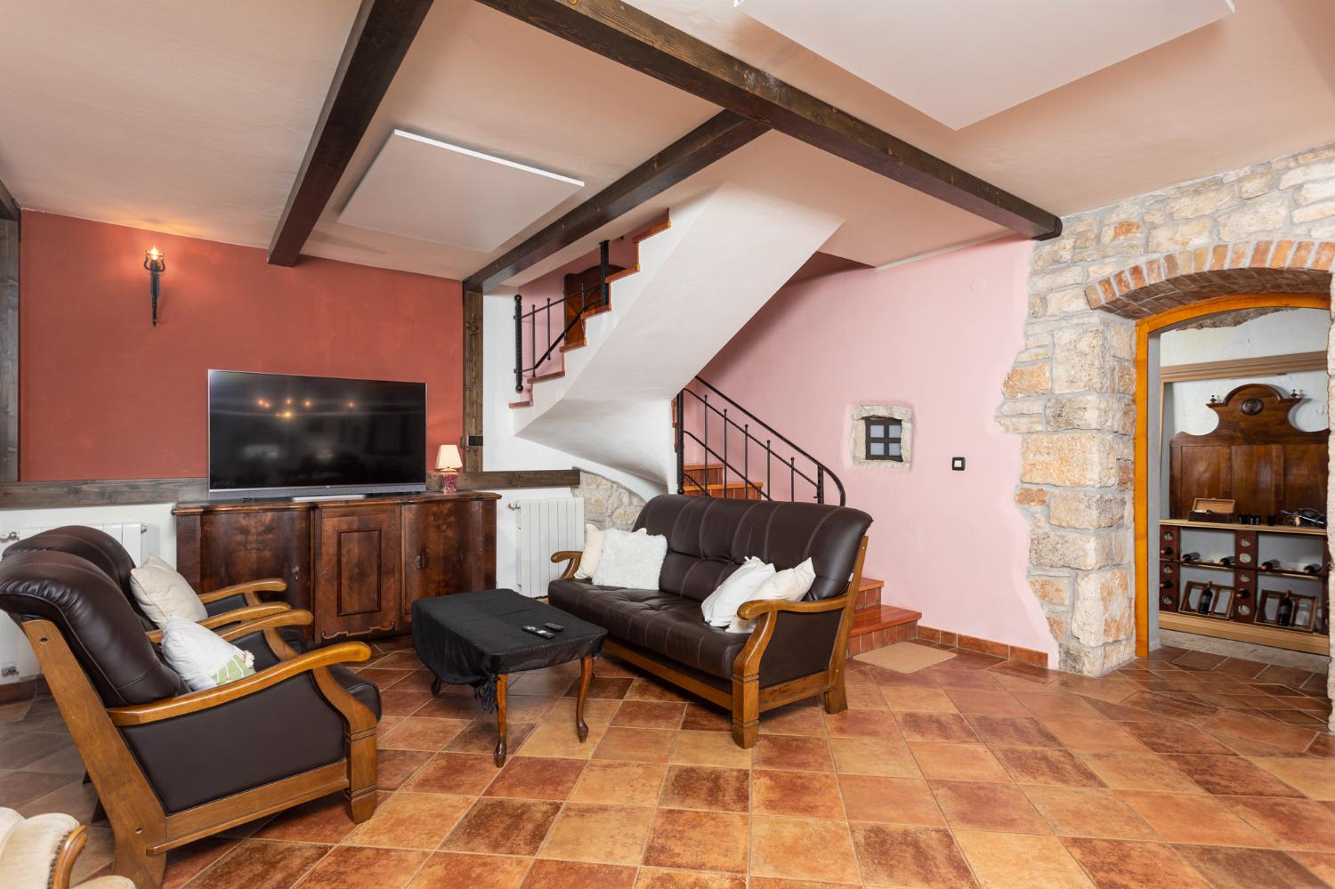 Living room on ground floor with sofas, dining area, ornamental fireplace, WiFi internet, and satellite TV