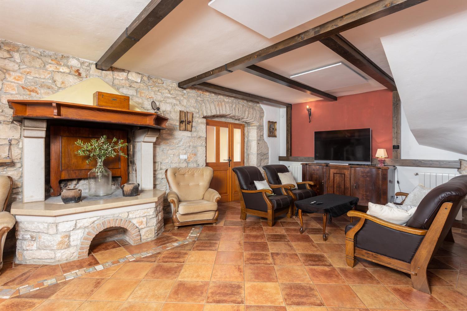Living room on ground floor with sofas, dining area, ornamental fireplace, WiFi internet, and satellite TV