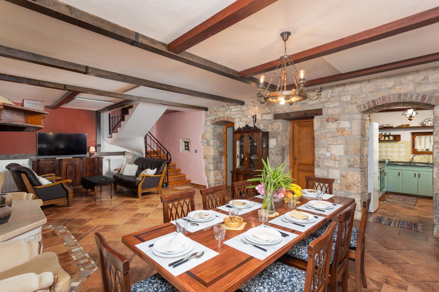 Living room on ground floor with sofas, dining area, ornamental fireplace, WiFi internet, and satellite TV