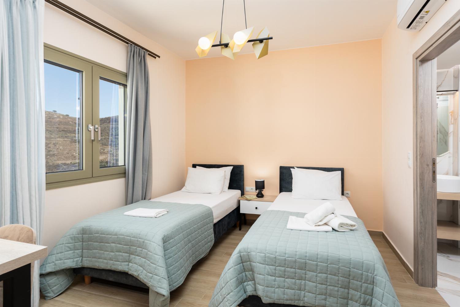 Twin bedroom with en suite bathroom and A/C