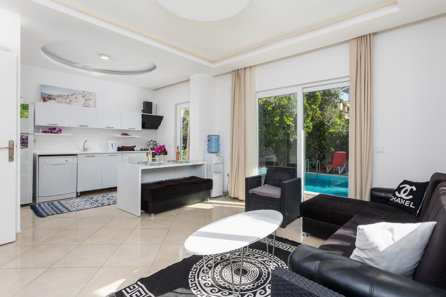 Open-plan living room with equipped kitchen, sofa, dining area,  A/C, WiFi internet, and satellite TV