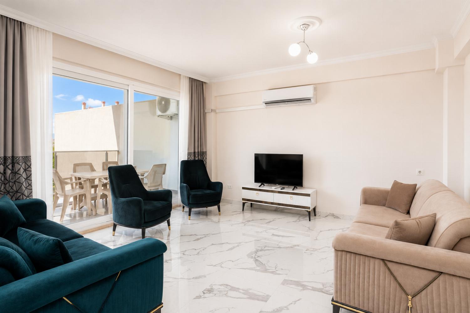 Open-plan living room with sofas, kitchen, A/C, WiFi internet and satellite TV