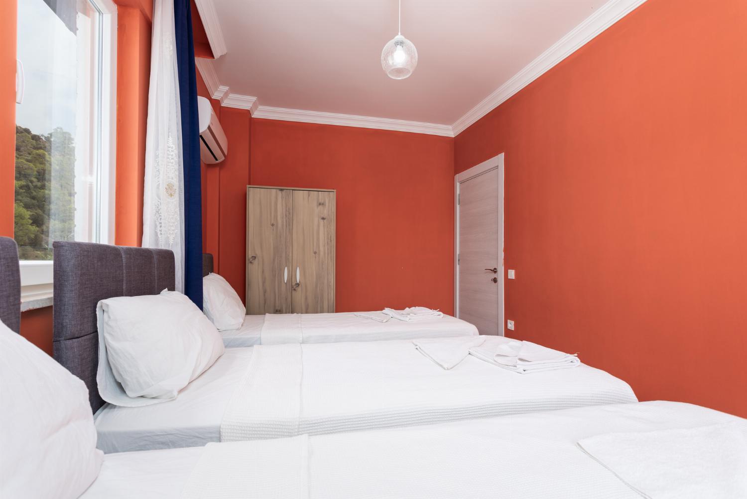 Bedroom with three single beds and A/C