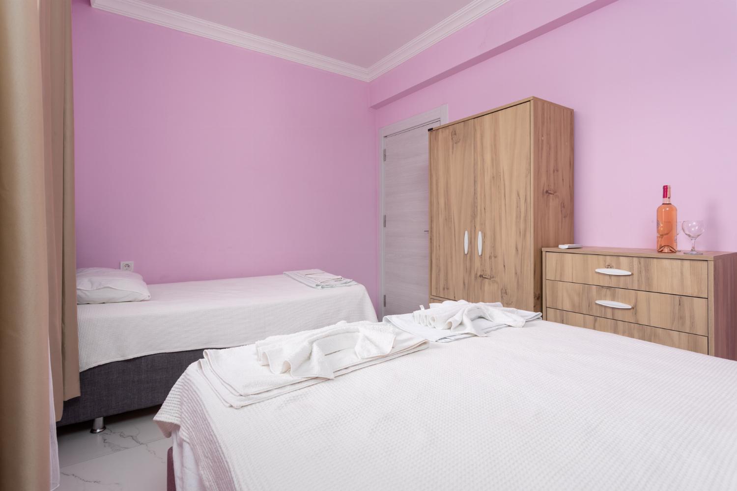 Bedroom with double bed and single bed, and A/C