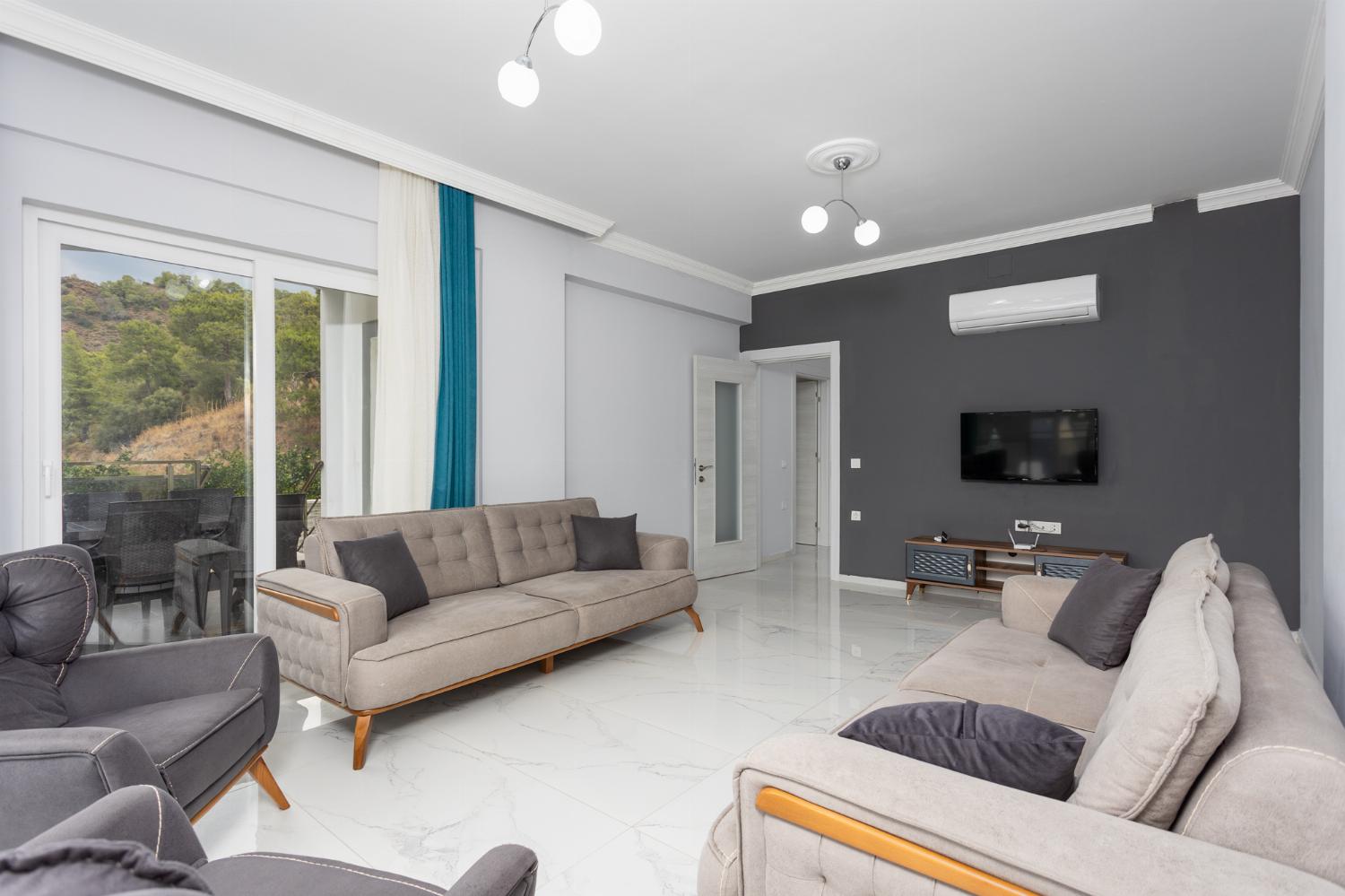 Living room with sofas, A/C, WiFi internet, and satellite TV